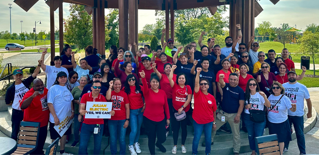 Workers and allies hold pro-union signs and raise their fists in a show of collective power.